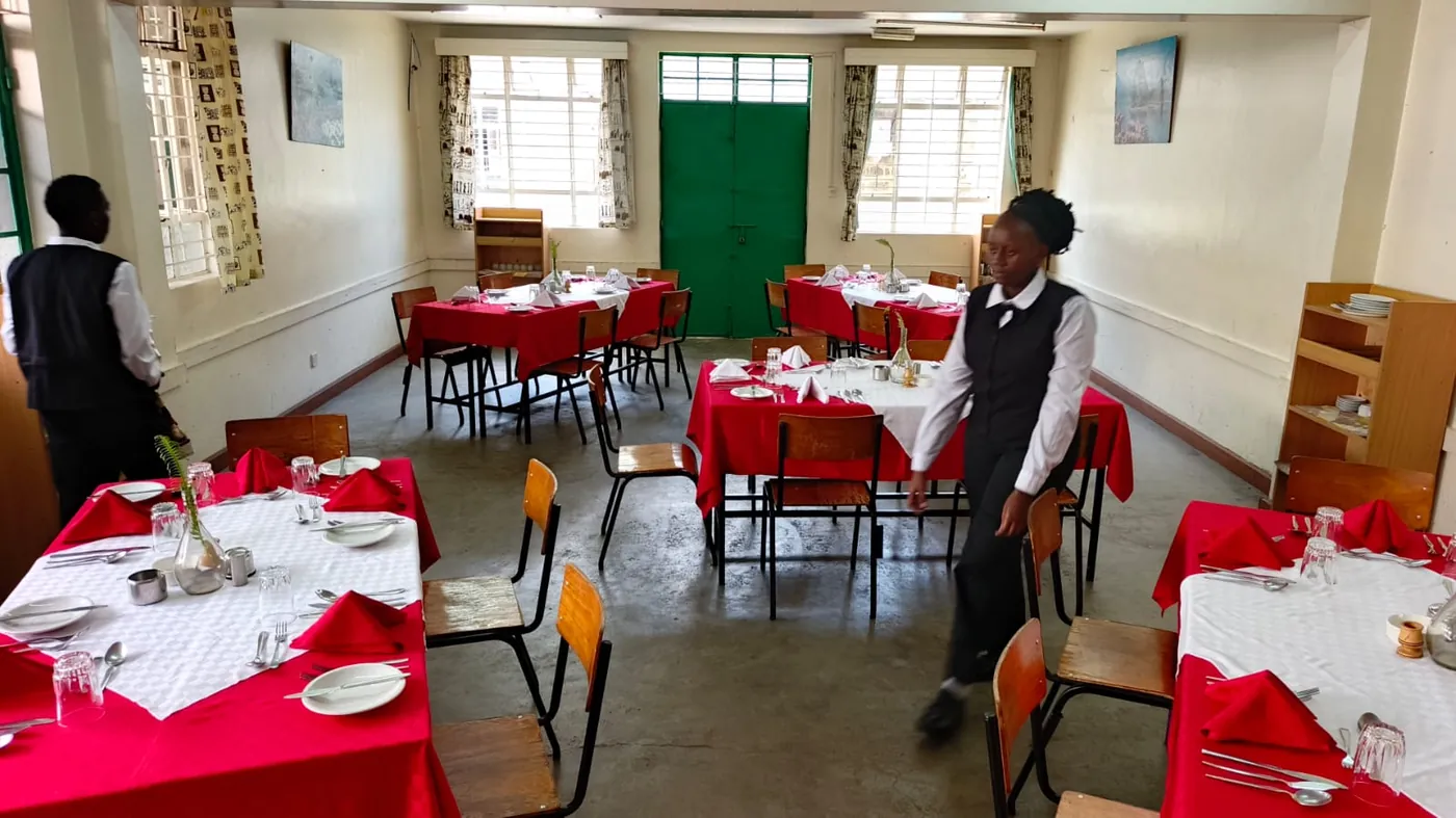 Hospitality trainees preparing the restaurant for service