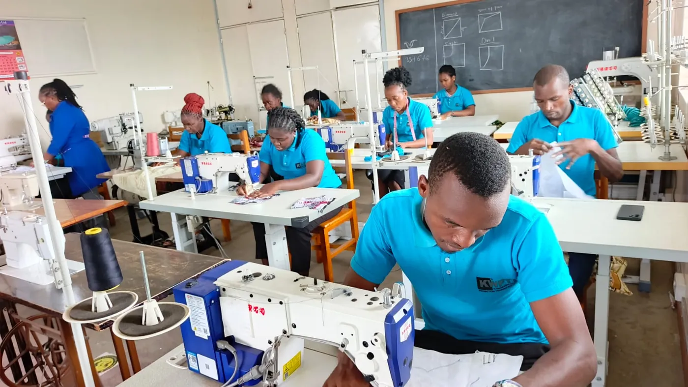 Dressmaking students practising on sewing machines
