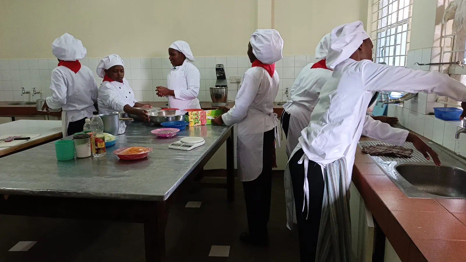 KWPTI catering students working together in the training kitchen