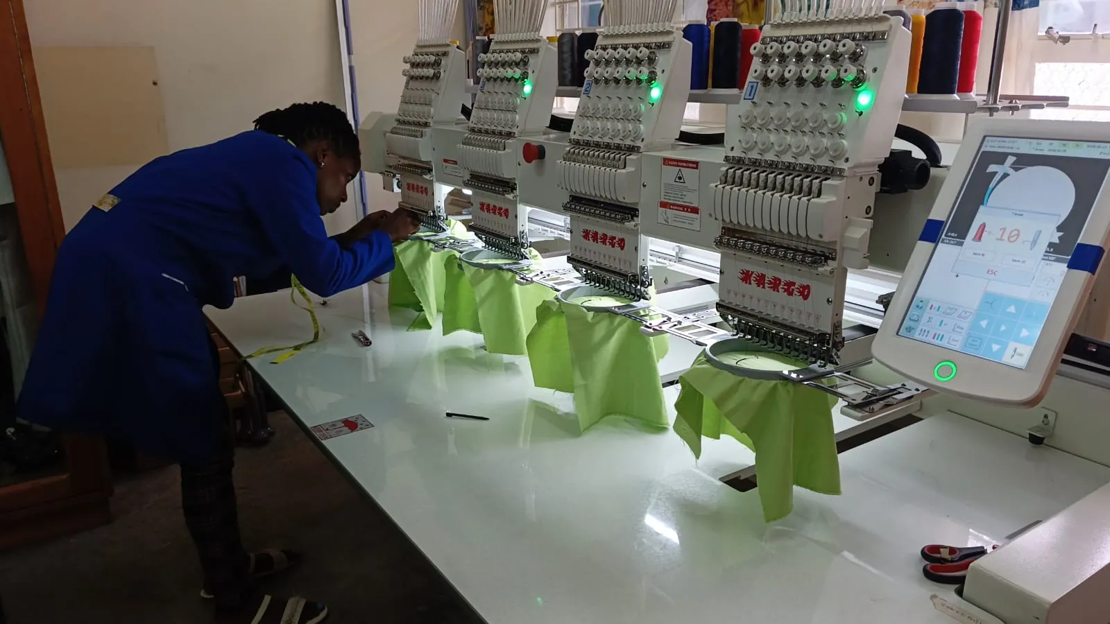 A learner operating KWPTI's multi-head embroidery machine