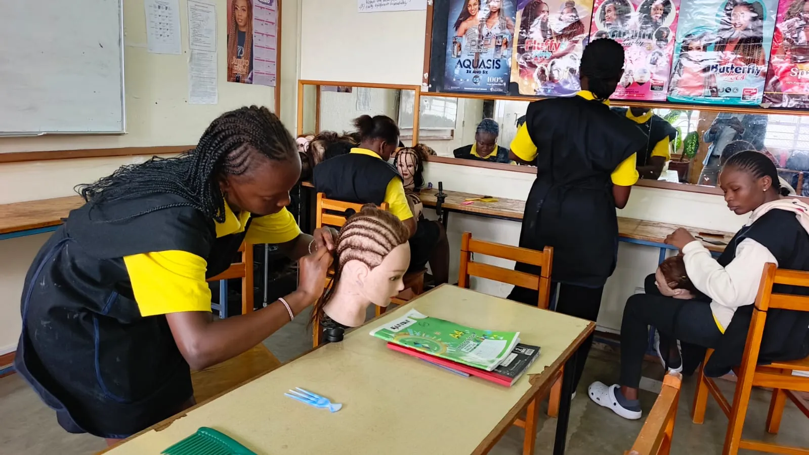 KWPTI hairdressing students practising braiding techniques