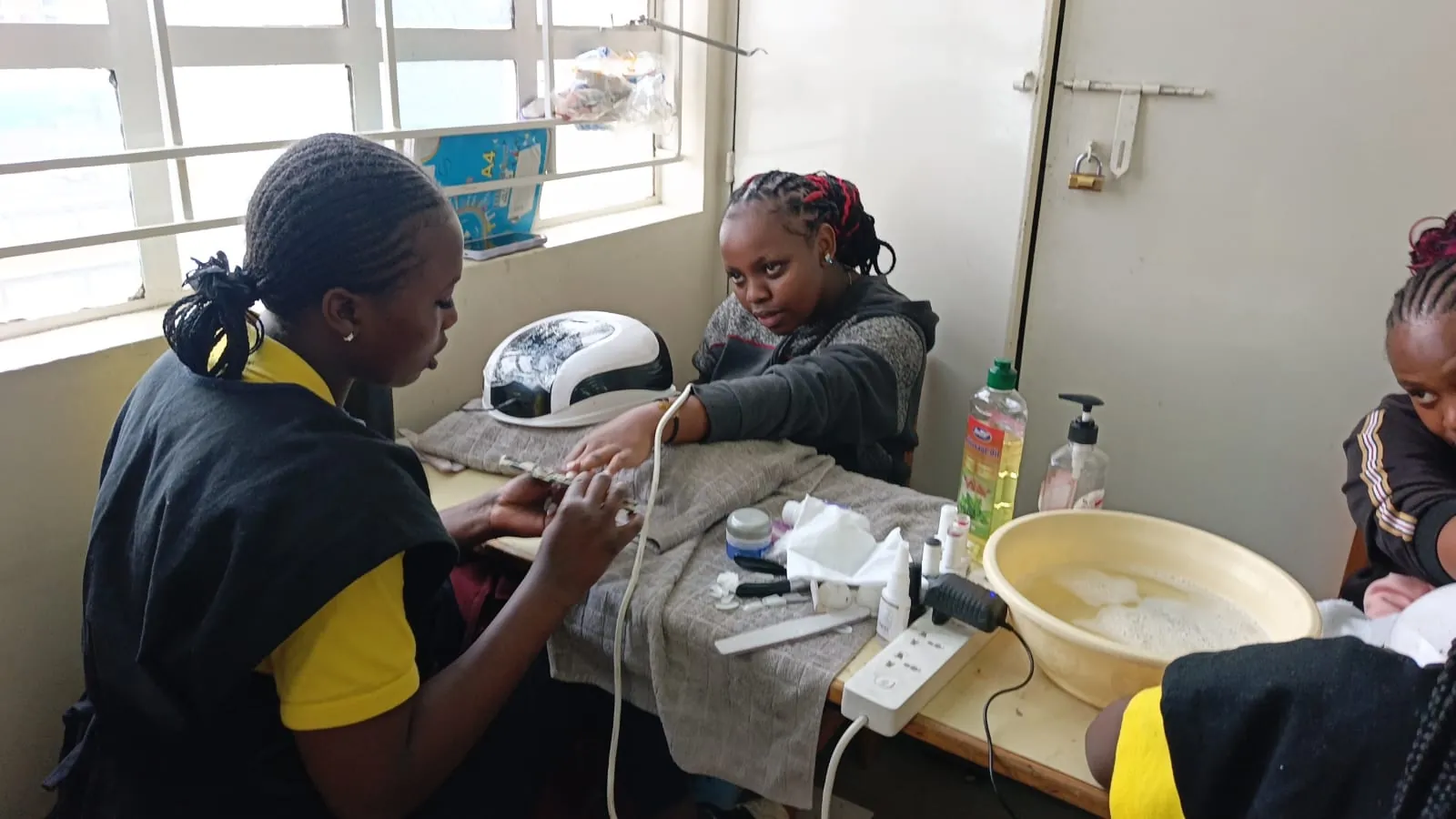 A KWPTI Nail Technology student practising a manicure